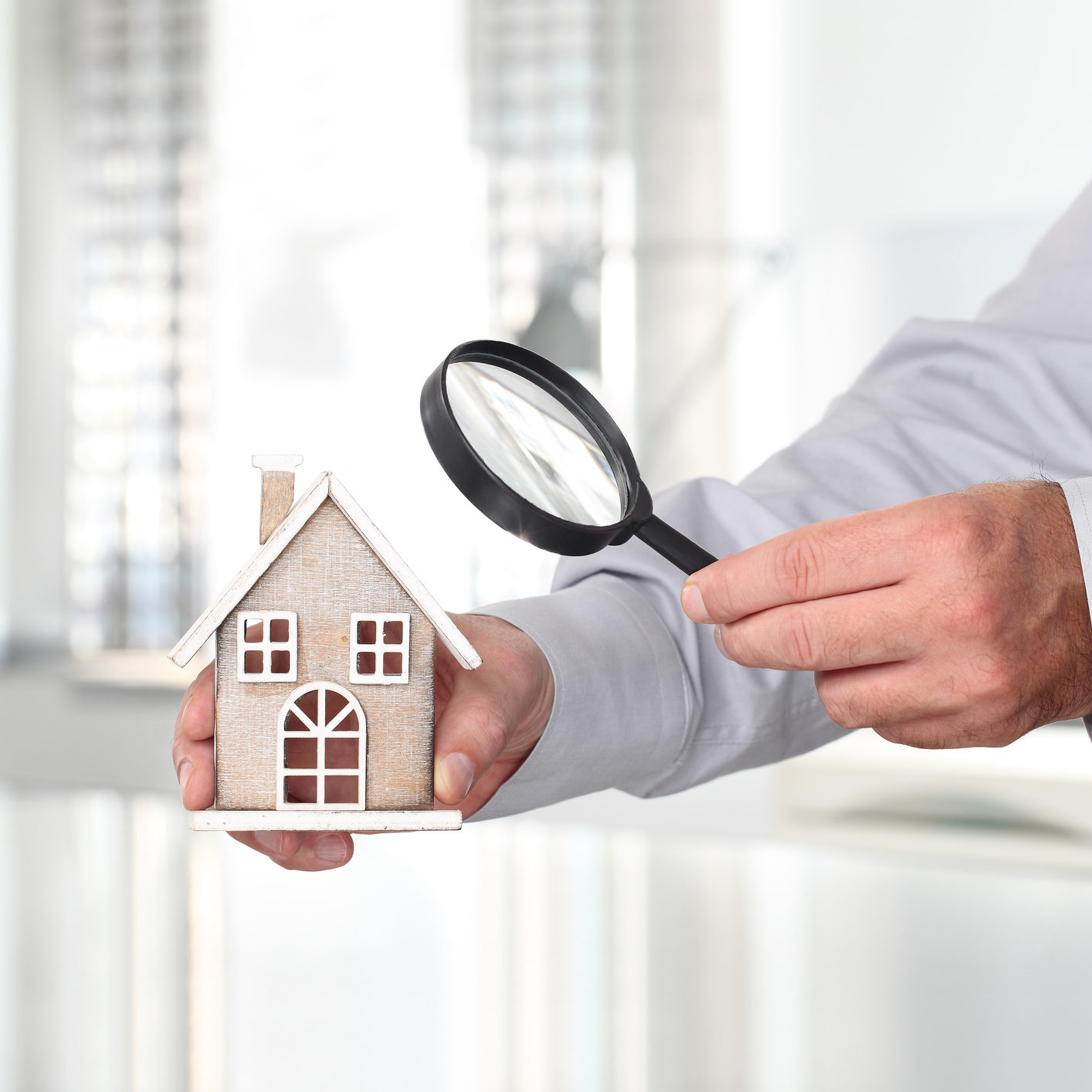 Hands with house and magnifying glass, search home concept become a foster parent