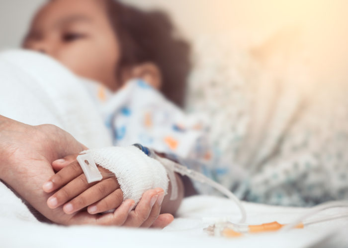 Mother hand holding child hand who have IV solution in the hospital with love and care Mother hand holding child hand who have IV solution in the hospital with love and care